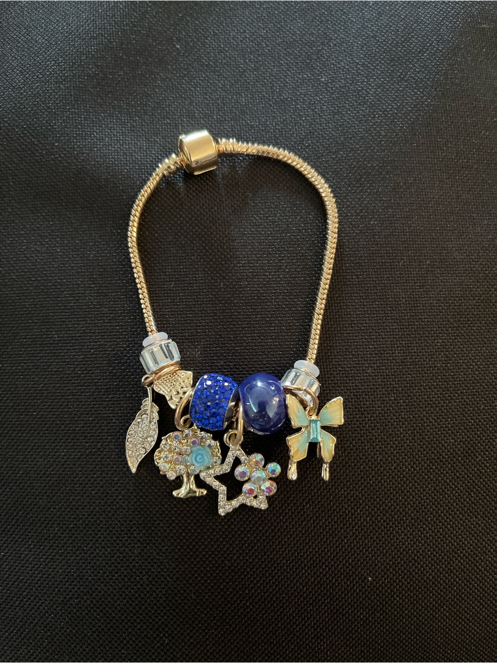 Gold Tone Bracelet with Blue Beads and Iridescent Charms